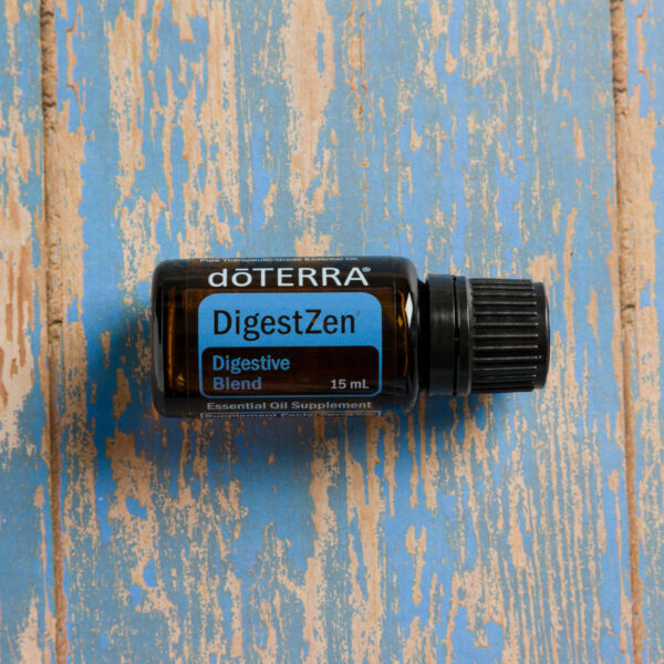 doTerra DigestZen essential oil 15ml vial on a table.